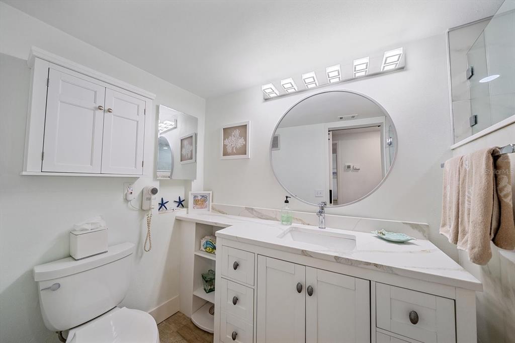 100 Sands Point Road, Unit 225 Longboat Key, FL 34228 - Photo 12 of 41 a bathroom with a toilet sink and mirror