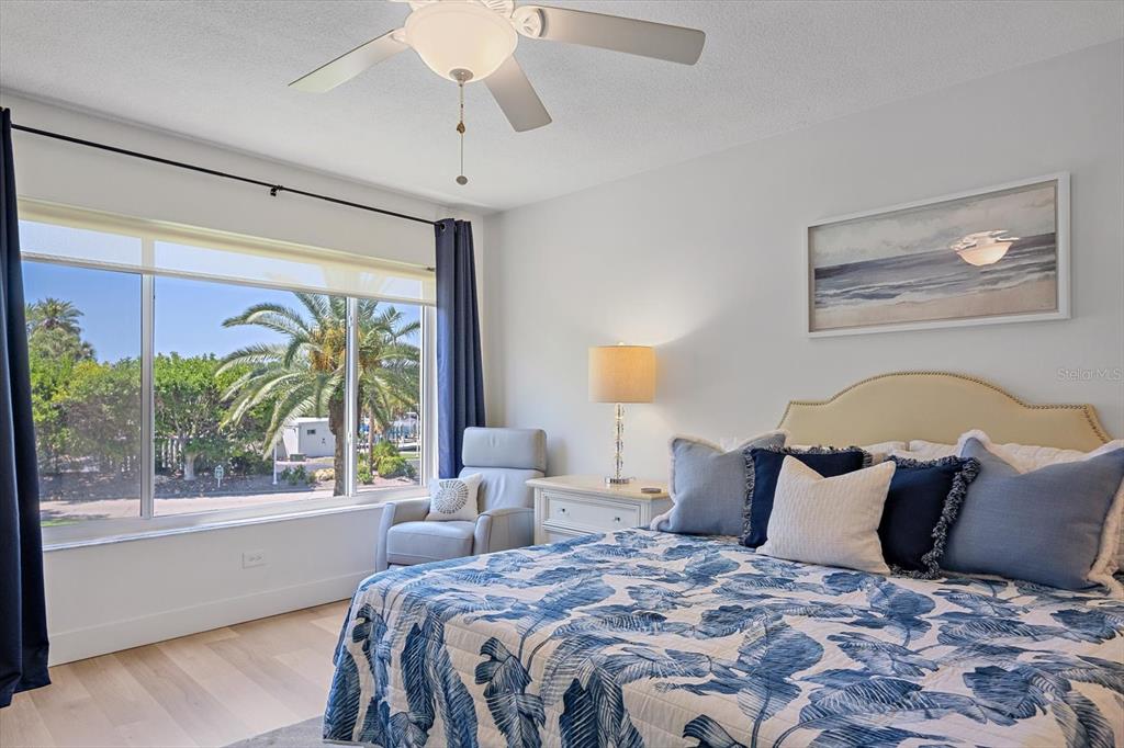 100 Sands Point Road, Unit 225 Longboat Key, FL 34228 - Photo 14 of 41 a large bed sitting in a bedroom next to a window
