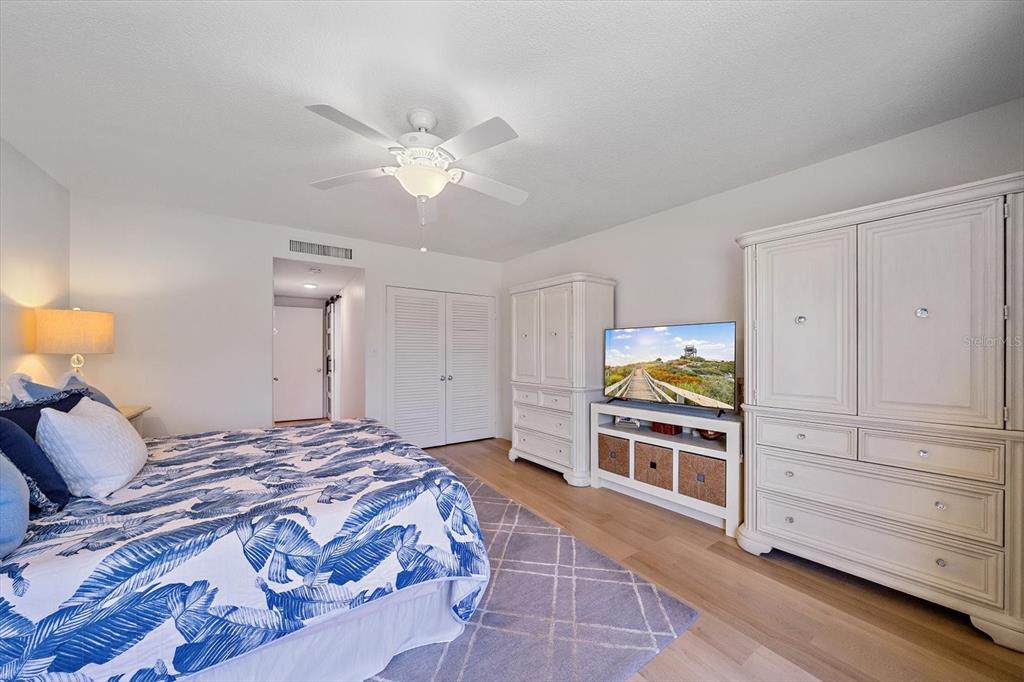 100 Sands Point Road, Unit 225 Longboat Key, FL 34228 - Photo 16 of 41 a bedroom with a bed and a chandelier