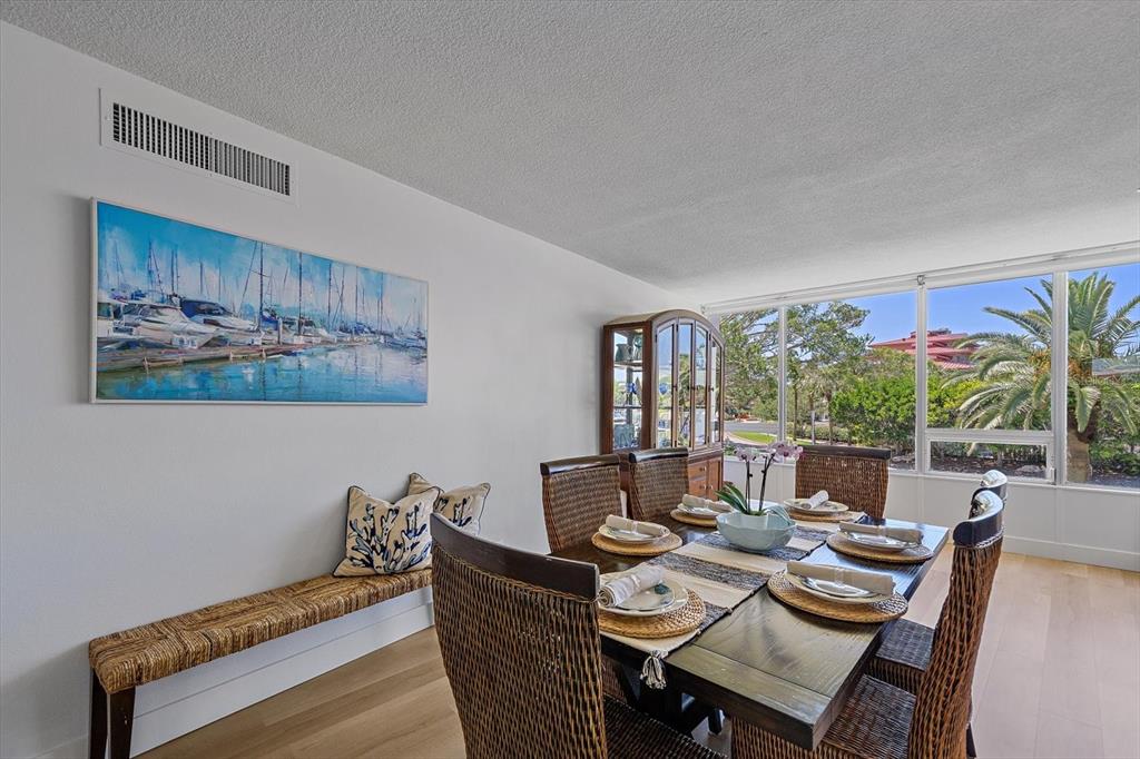 100 Sands Point Road, Unit 225 Longboat Key, FL 34228 - Photo 22 of 41 a dining room with furniture and a large window