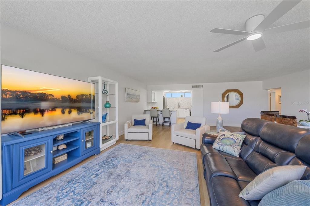 100 Sands Point Road, Unit 225 Longboat Key, FL 34228 - Photo 23 of 41 a living room with furniture a window and flat screen tv