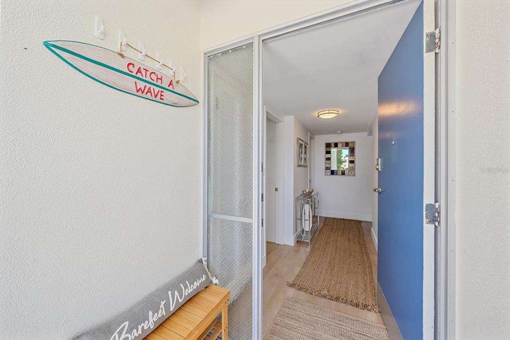 100 Sands Point Road, Unit 225 Longboat Key, FL 34228 - Photo 5 of 41 a view of a hallway with wooden floor and staircase