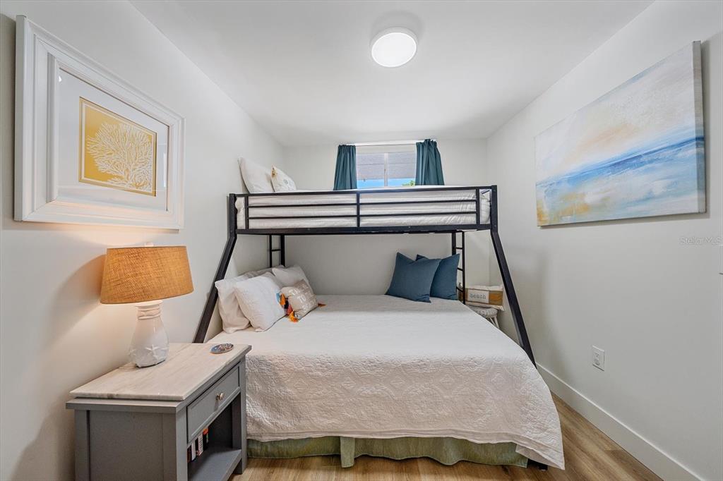 100 Sands Point Road, Unit 225 Longboat Key, FL 34228 - Photo 7 of 41 a bedroom with a bed and a lamp on table