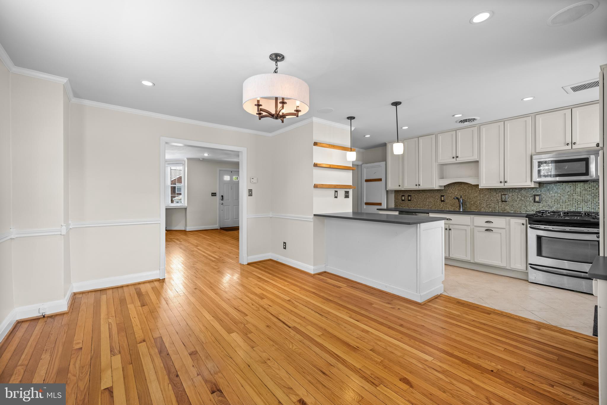 6449 Blenheim Road Baltimore, MD 21212 - Photo 11 of 36 a kitchen with stainless steel appliances a refrigerator and a stove top oven
