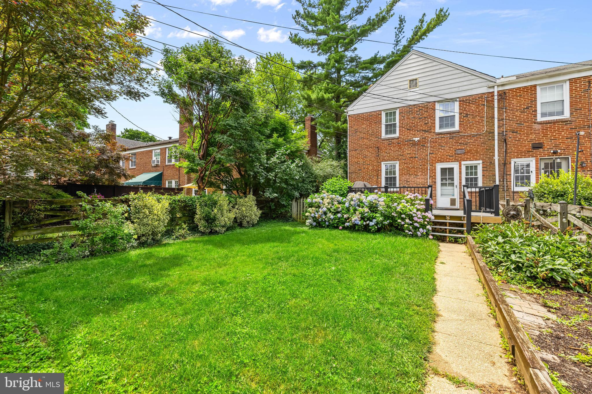 6449 Blenheim Road Baltimore, MD 21212 - Photo 33 of 36 a front view of a house with a yard and potted plants