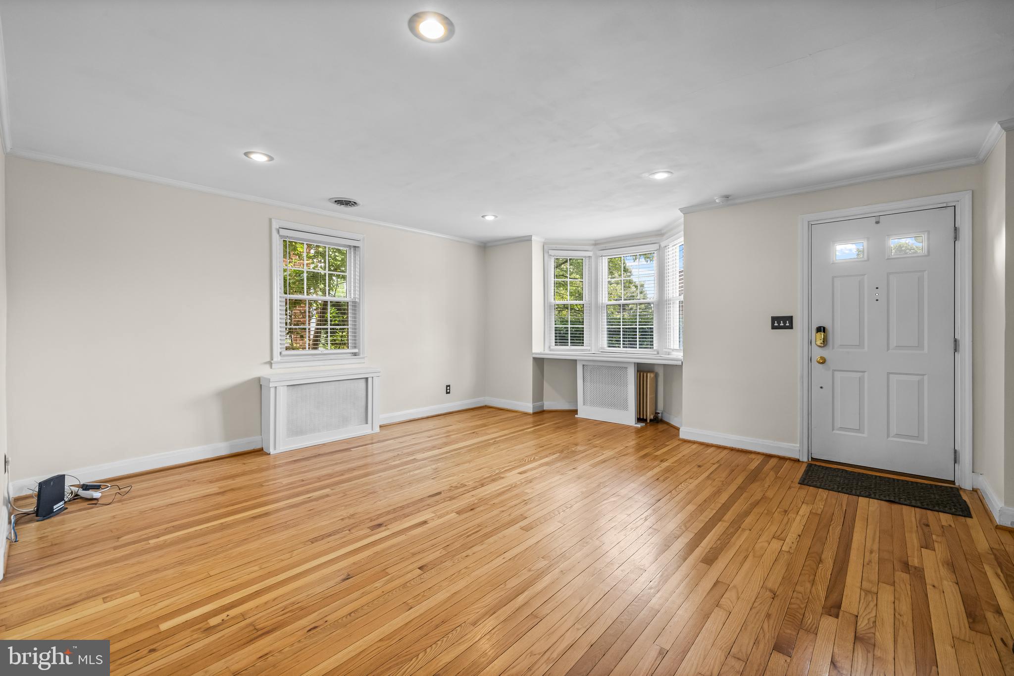 6449 Blenheim Road Baltimore, MD 21212 - Photo 4 of 36 a view of an empty room with a window and wooden floor