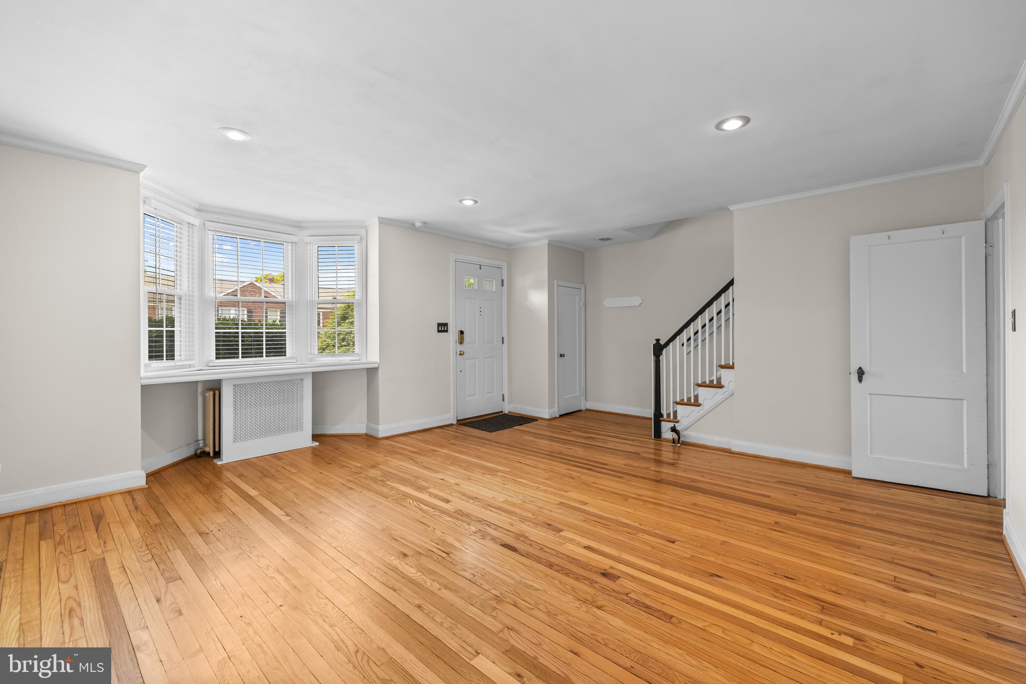 6449 Blenheim Road Baltimore, MD 21212 - Photo 5 of 36 a big room with wooden floor and windows