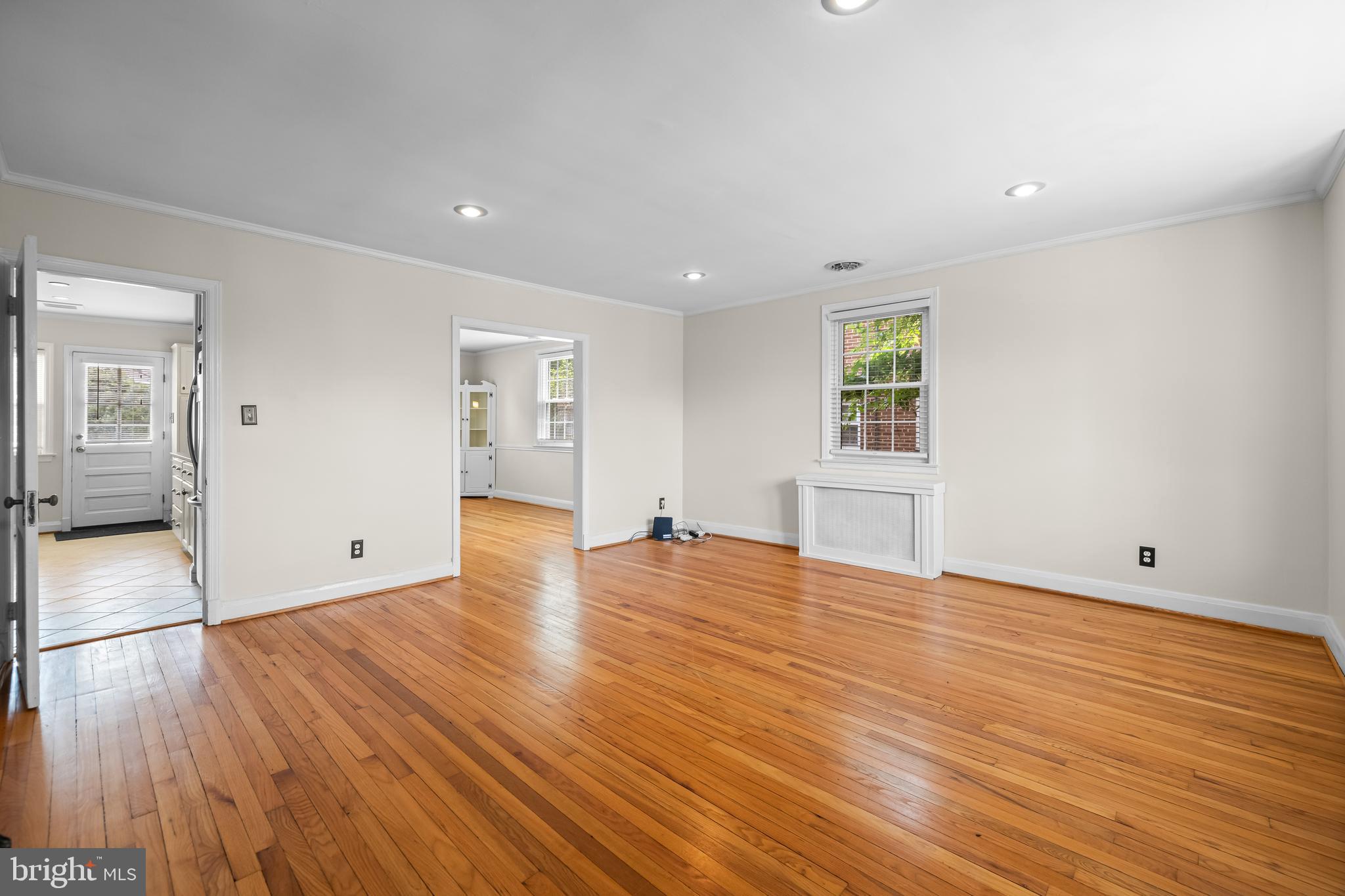 6449 Blenheim Road Baltimore, MD 21212 - Photo 7 of 36 a view of empty room with wooden floor and fireplace
