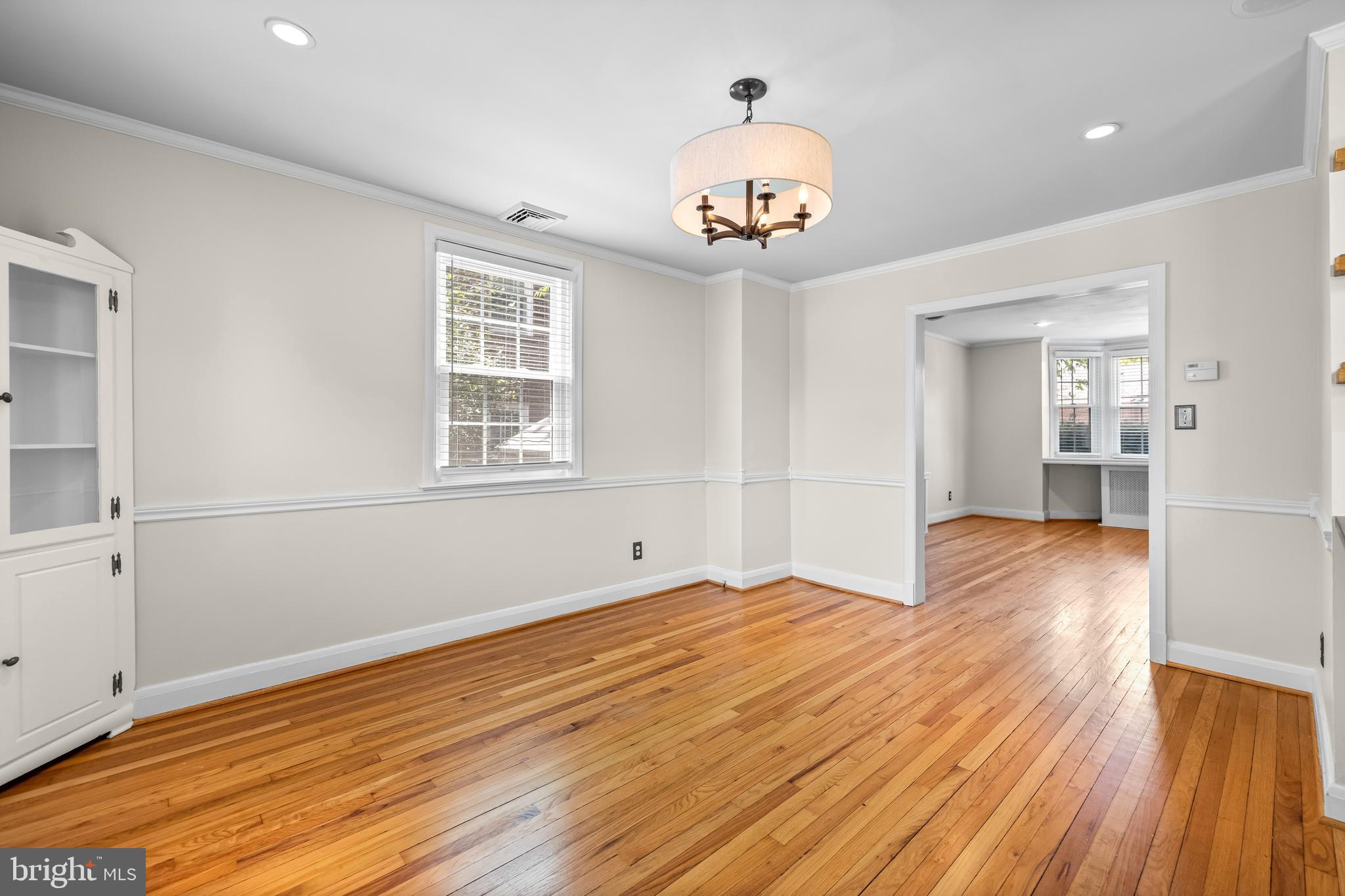 6449 Blenheim Road Baltimore, MD 21212 - Photo 10 of 36 a view of an empty room with wooden floor and a window