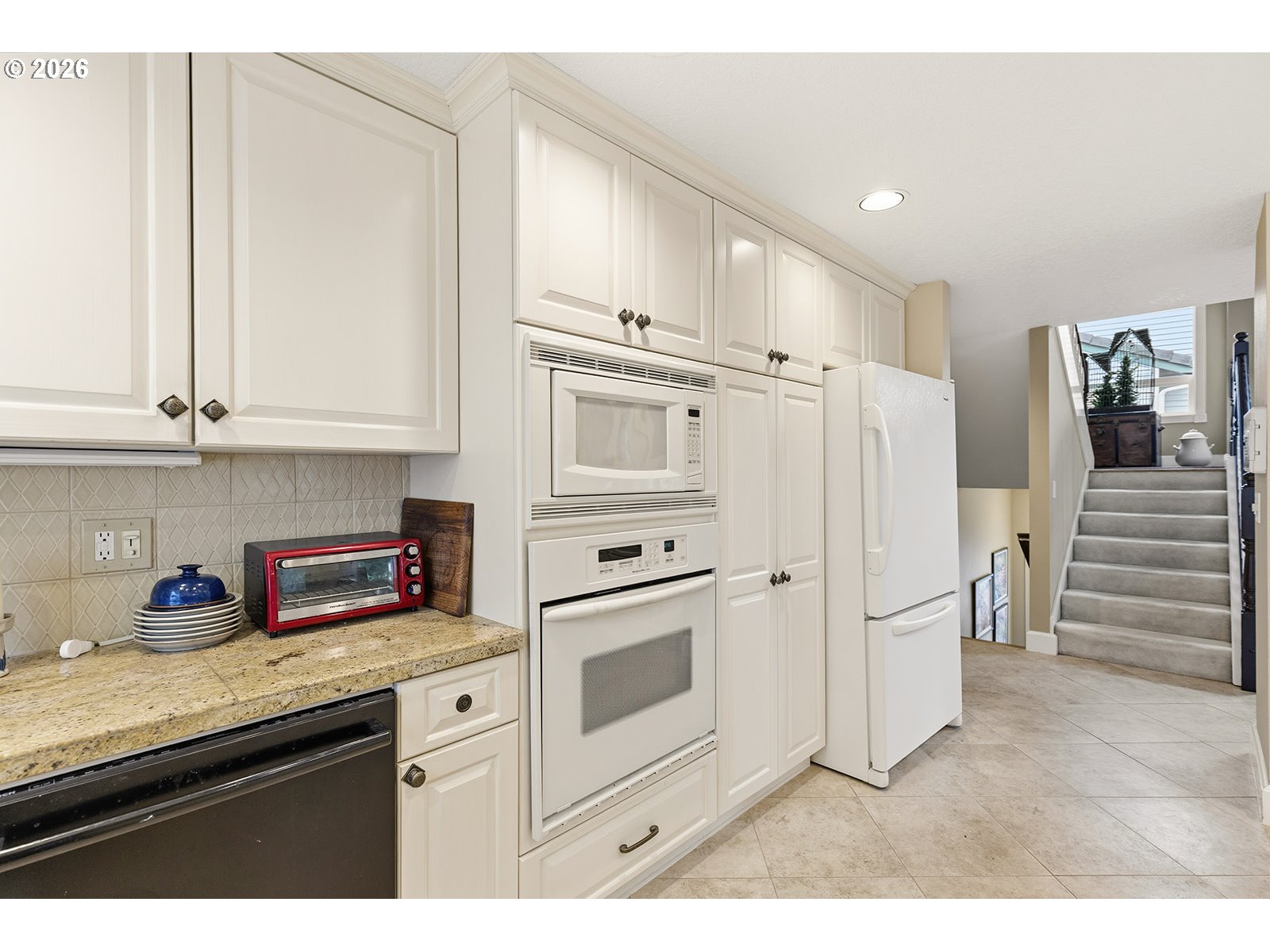 15917 Northeast Union Road, Unit 16 Ridgefield, WA 98642 - Photo 12 of 47 a kitchen with stainless steel appliances granite countertop a refrigerator and a stove top oven