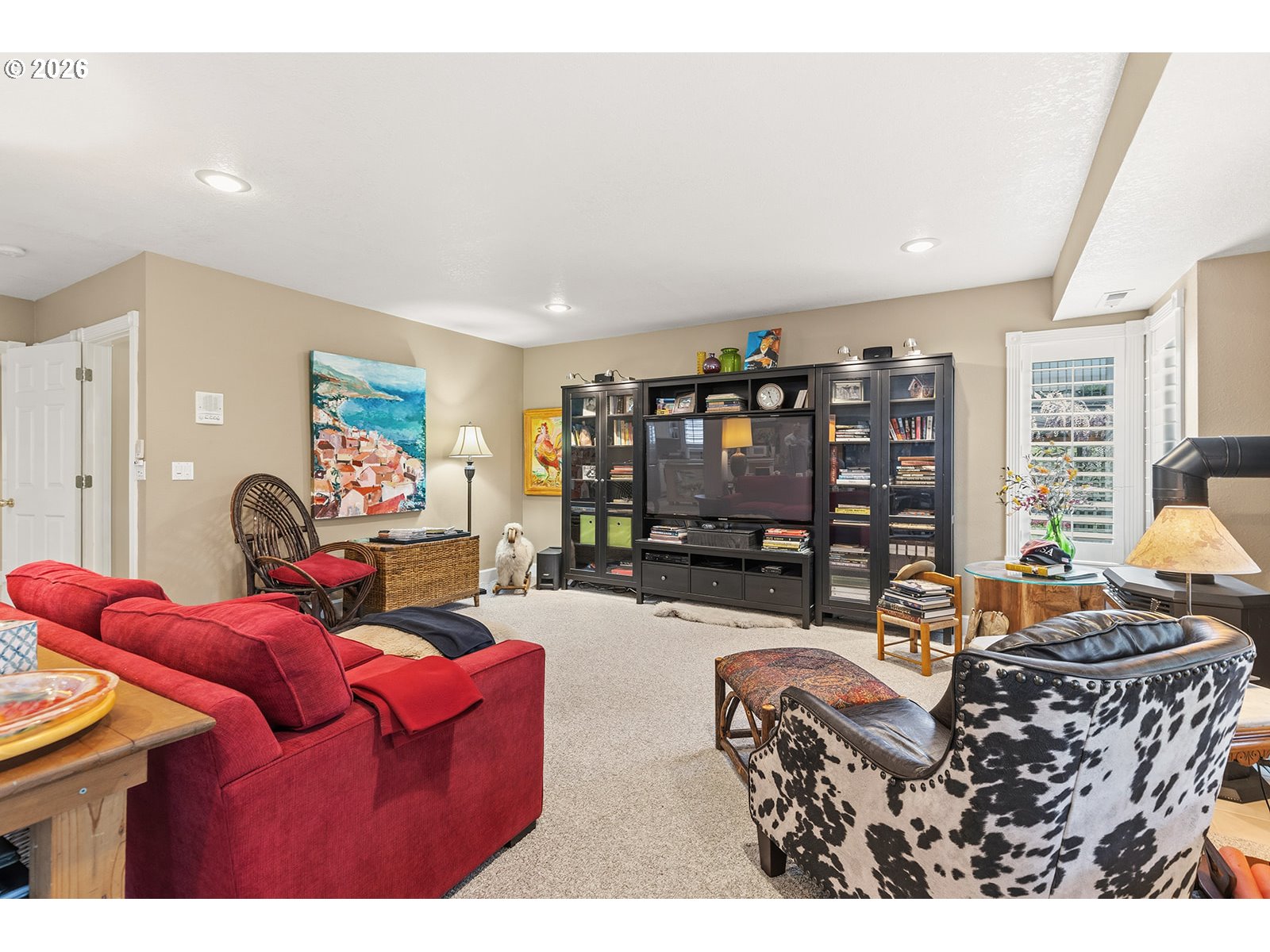 15917 Northeast Union Road, Unit 16 Ridgefield, WA 98642 - Photo 38 of 47 a living room with furniture a red couch and a bookshelf