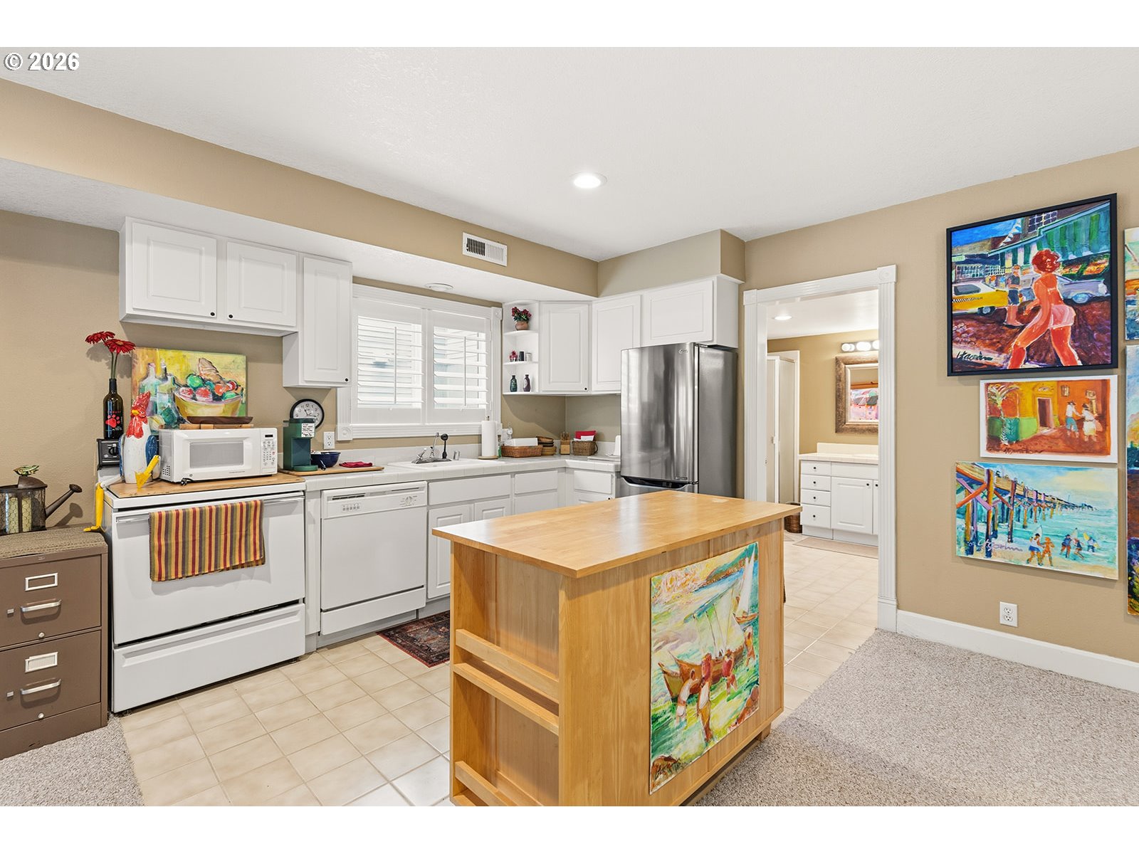 15917 Northeast Union Road, Unit 16 Ridgefield, WA 98642 - Photo 41 of 47 a kitchen with stainless steel appliances granite countertop a stove a refrigerator a sink dishwasher and white cabinets with wooden floor