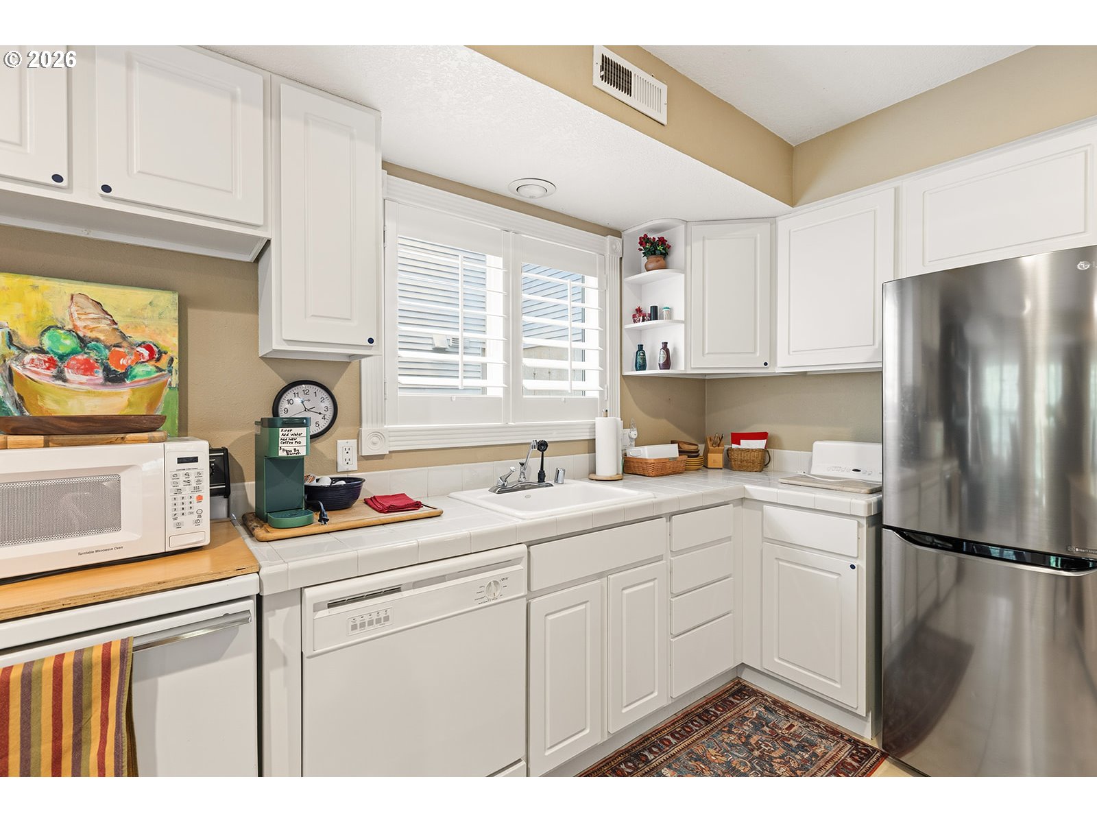 15917 Northeast Union Road, Unit 16 Ridgefield, WA 98642 - Photo 43 of 47 a kitchen with stainless steel appliances a refrigerator sink and cabinets