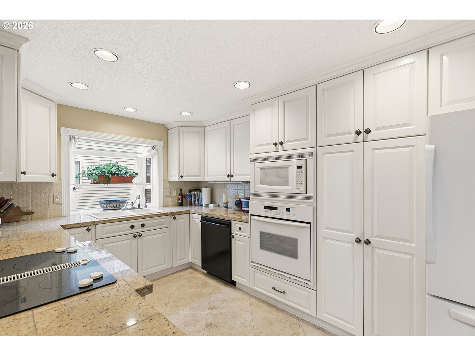 15917 Northeast Union Road, Unit 16 Ridgefield, WA 98642 - Photo 10 of 47 a kitchen with white cabinets and white appliances