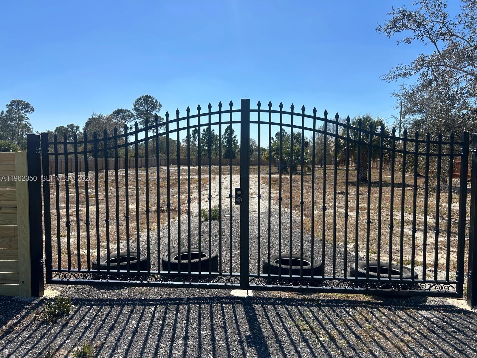 648 Hunting Club Avenue Clewiston, FL 33440 - Photo 11 of 22 a view of a black gate