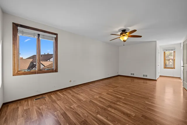 a view of empty room with a painting on the wall