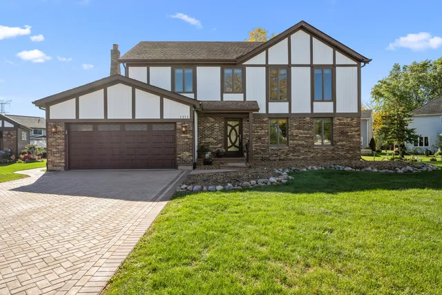 a front view of a house with a yard and garage