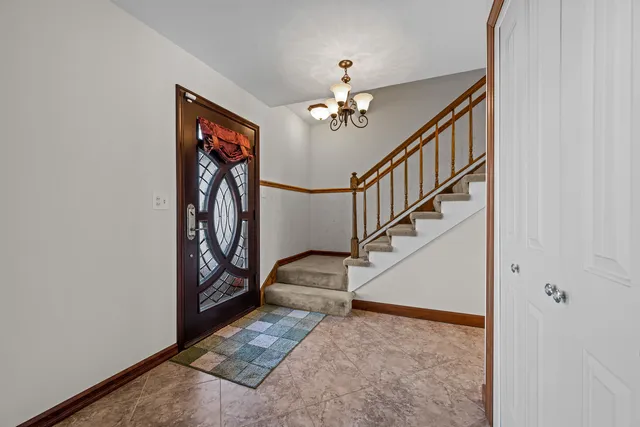 a view of entryway and hall with a chandelier