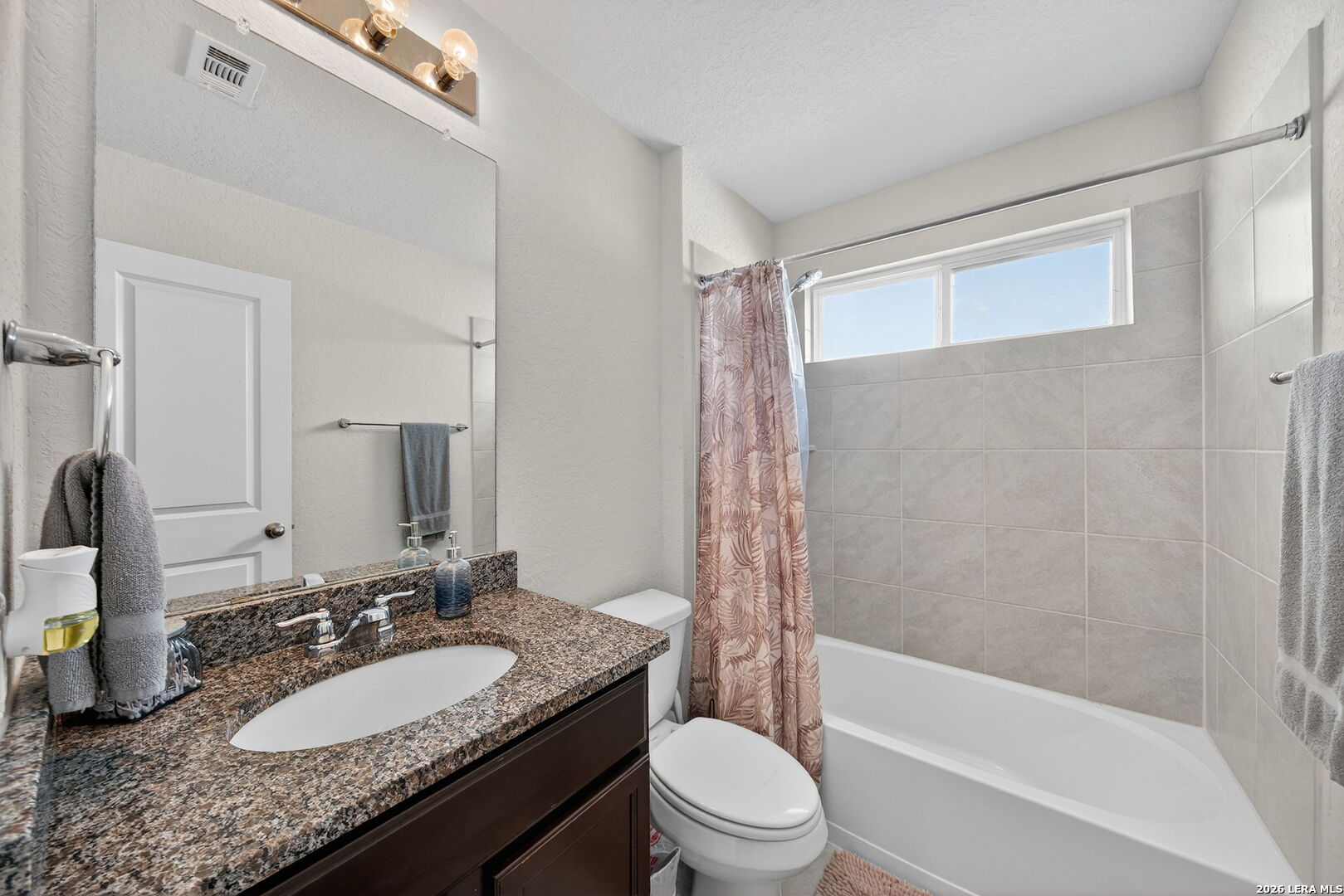 3653 Copper River Bulverde, TX 78163 - Photo 17 of 25 a bathroom with a granite countertop sink toilet mirror and shower