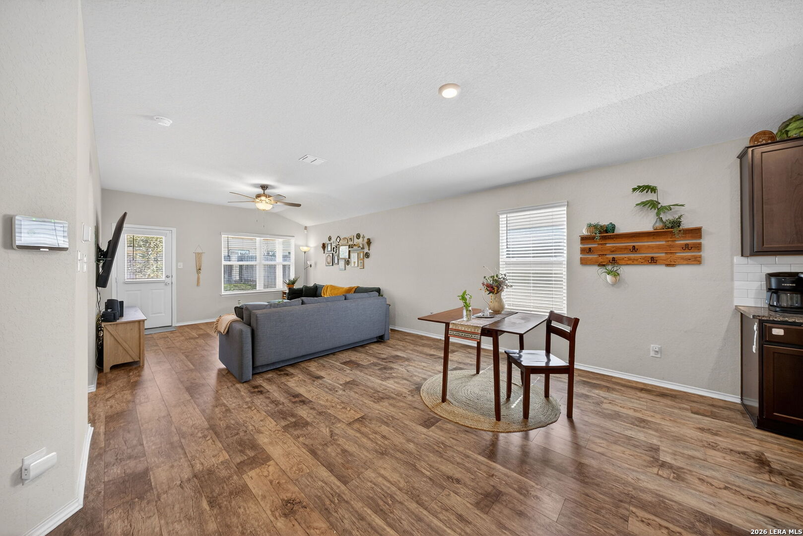 3653 Copper River Bulverde, TX 78163 - Photo 5 of 25 a living room with furniture a dining table and a flat screen tv