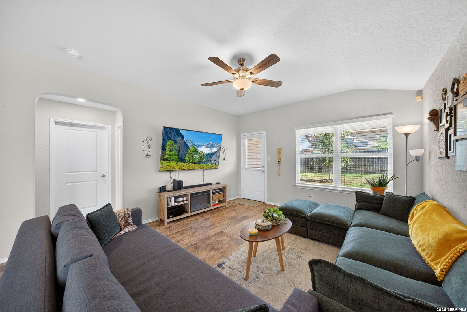 3653 Copper River Bulverde, TX 78163 - Photo 6 of 25 a living room with furniture a large window and a flat screen tv