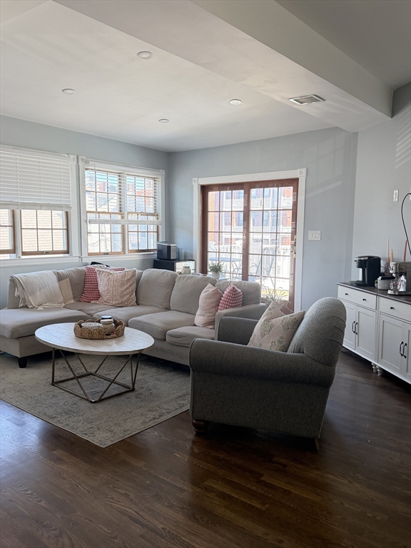 a living room with furniture a rug and a large window