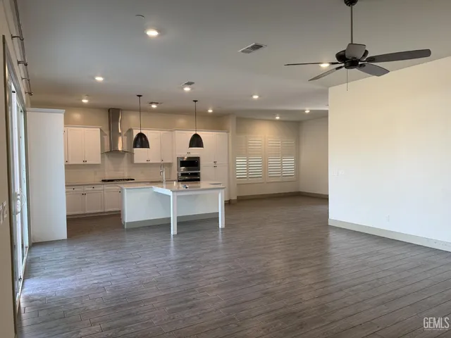 a view of kitchen with stainless steel appliances refrigerator microwave and stove