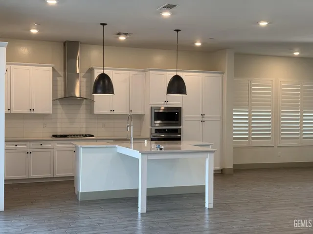 a kitchen with a sink stainless steel appliances and cabinets