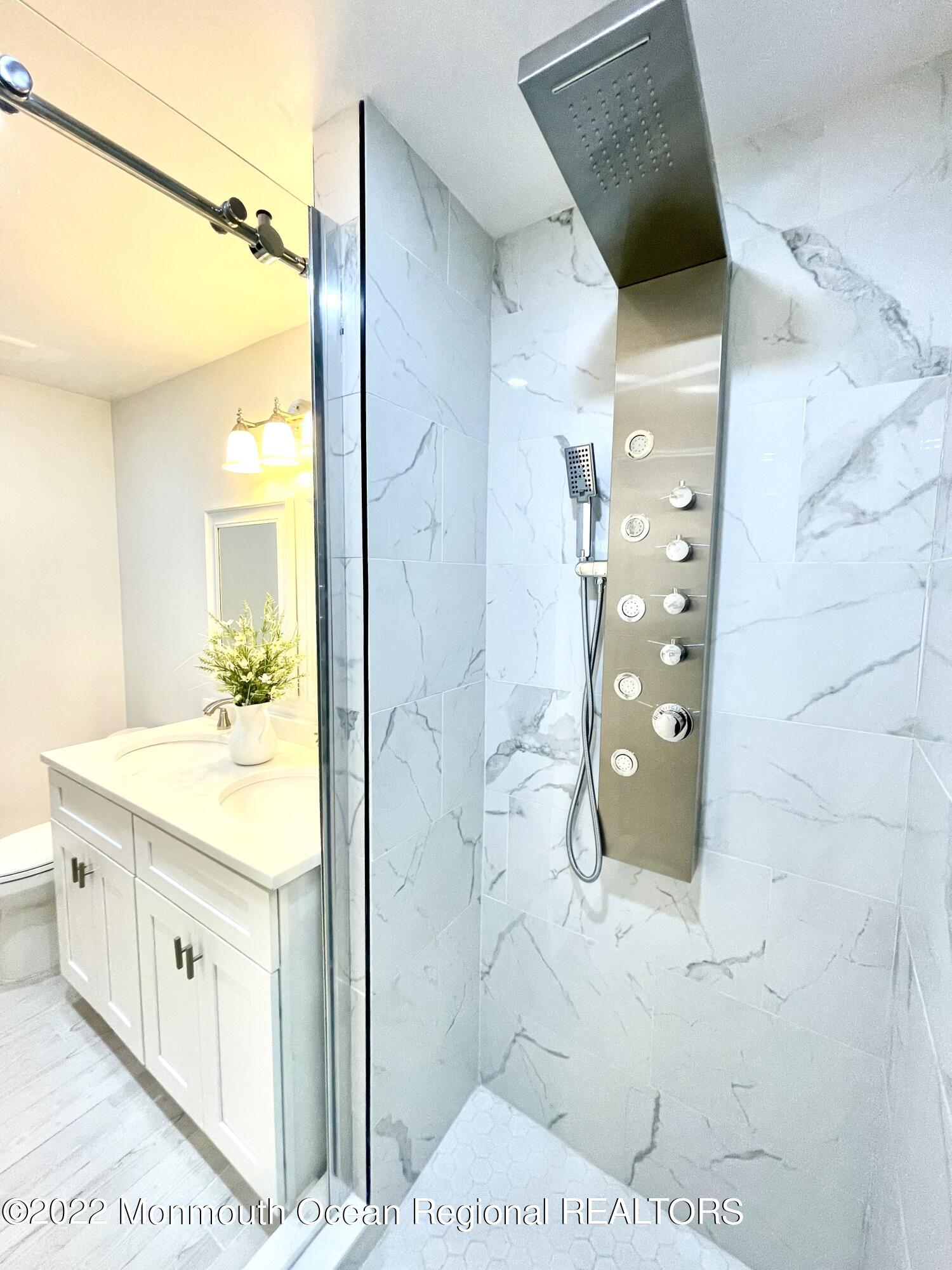 641 Thoroughfare Road Brick, NJ 08724 - Photo 16 of 48 a bathroom with a sink and a mirror