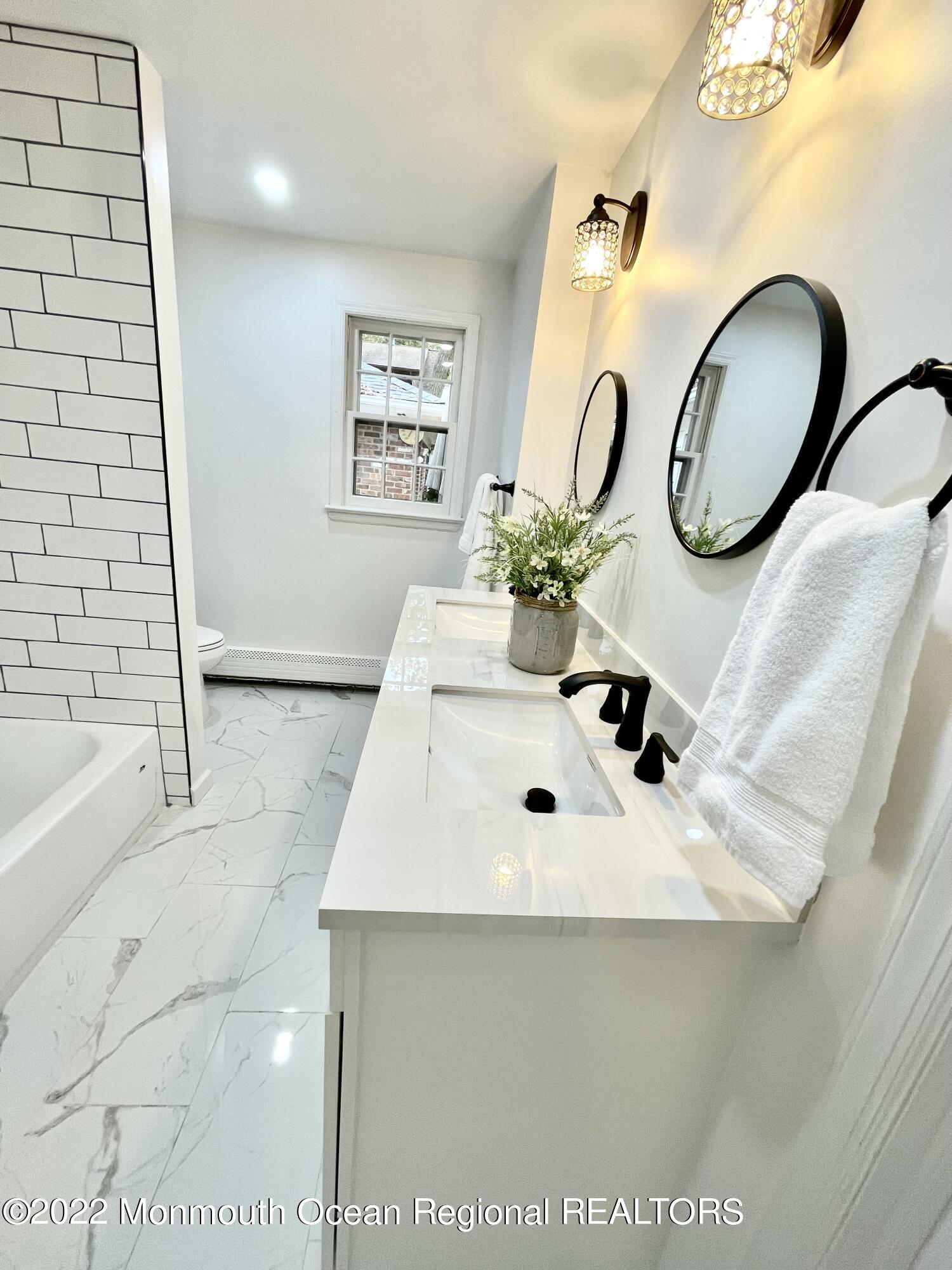 641 Thoroughfare Road Brick, NJ 08724 - Photo 21 of 48 a bathroom with a sink mirror and tub
