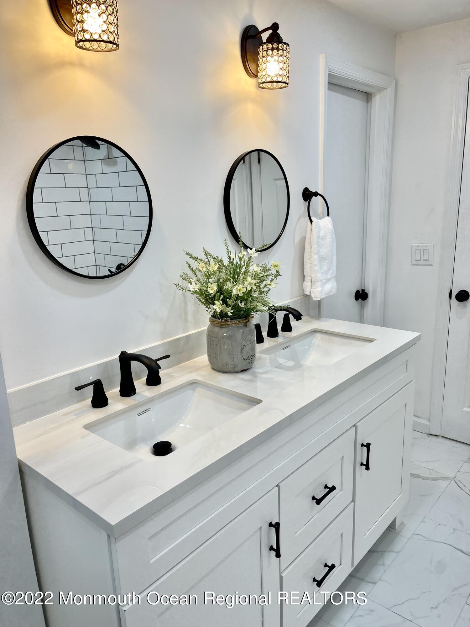 641 Thoroughfare Road Brick, NJ 08724 - Photo 22 of 48 a bathroom with a sink and a mirror