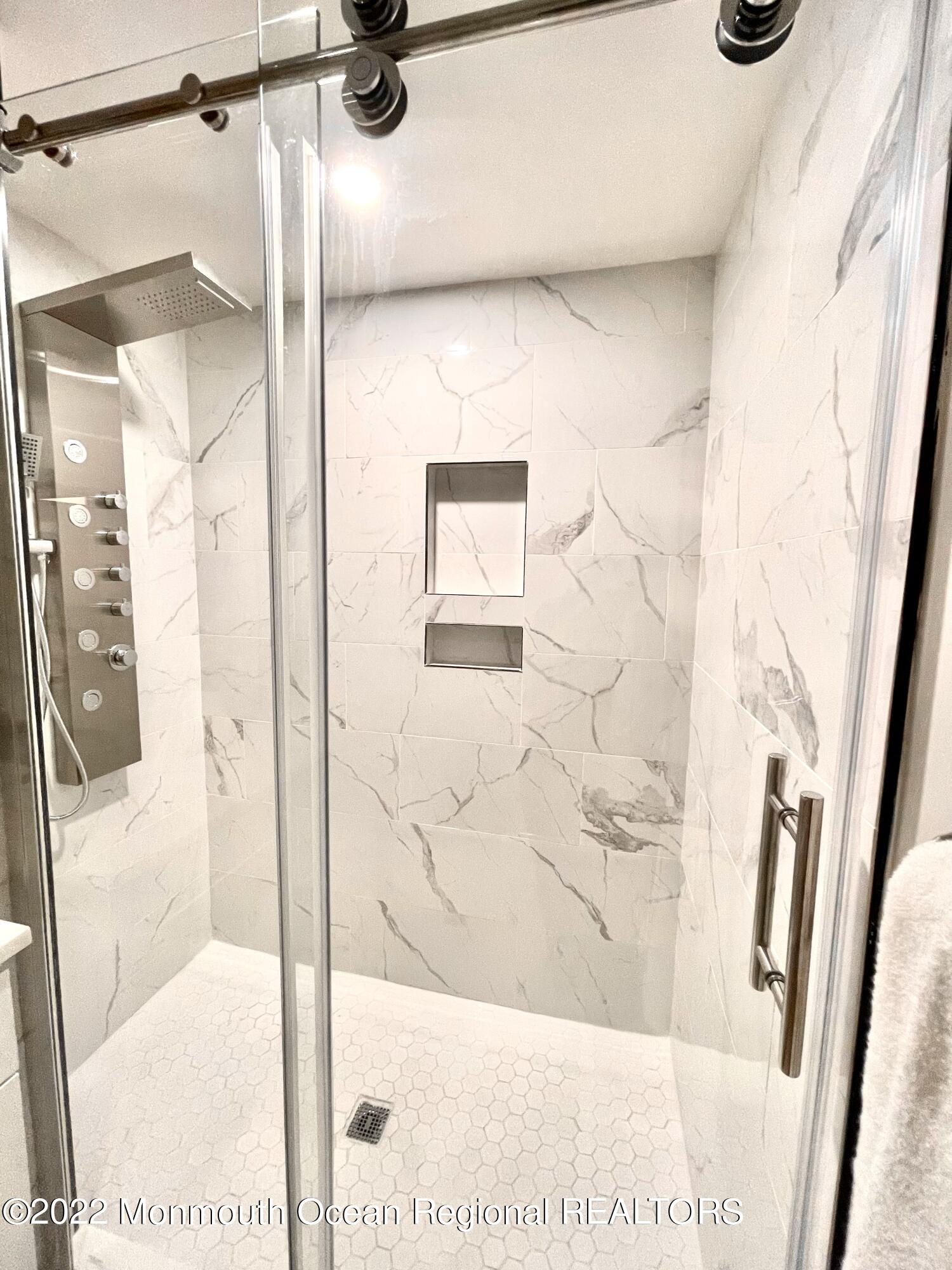 641 Thoroughfare Road Brick, NJ 08724 - Photo 23 of 48 a bathroom with a glass shower door