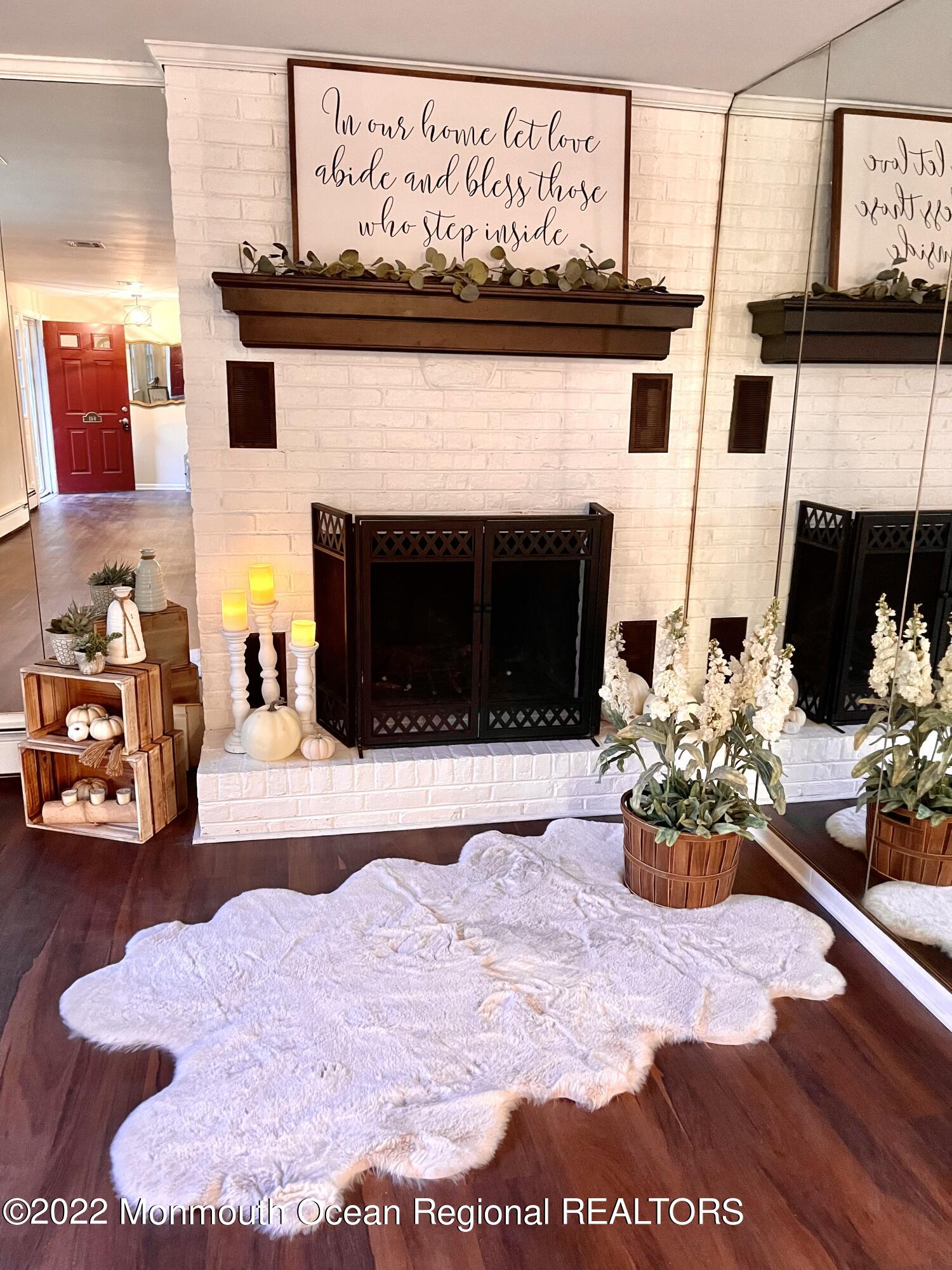 641 Thoroughfare Road Brick, NJ 08724 - Photo 3 of 48 a lobby with a fireplace furniture and a potted plant
