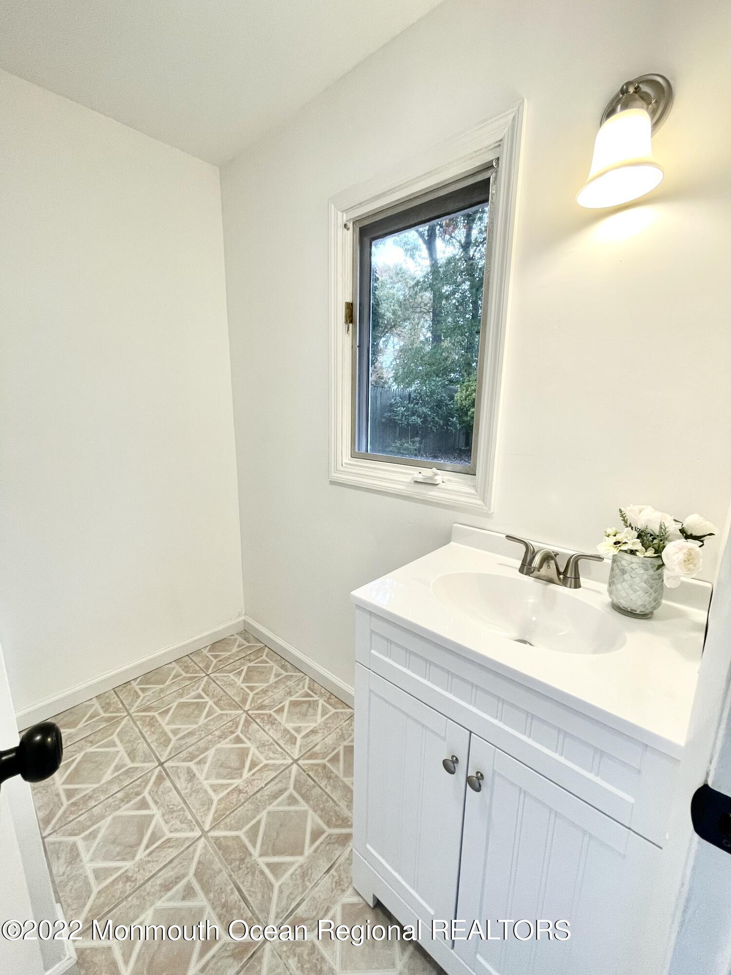 641 Thoroughfare Road Brick, NJ 08724 - Photo 33 of 48 a bathroom with a sink and a mirror