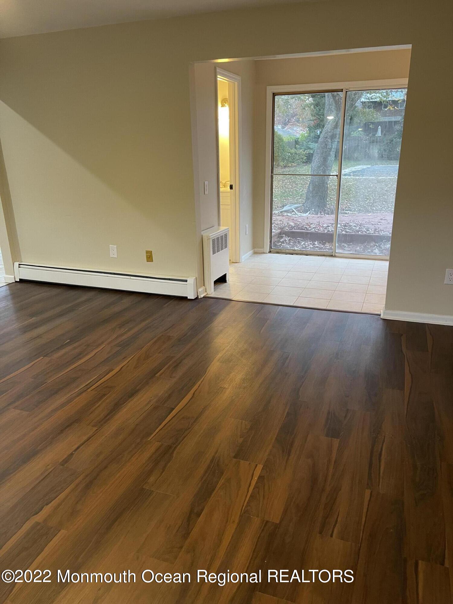 641 Thoroughfare Road Brick, NJ 08724 - Photo 36 of 48 an empty room with wooden floor and windows