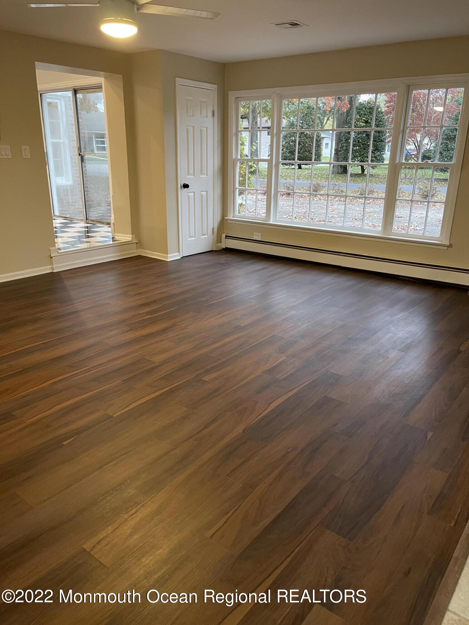 641 Thoroughfare Road Brick, NJ 08724 - Photo 37 of 48 an empty room with wooden floor and windows