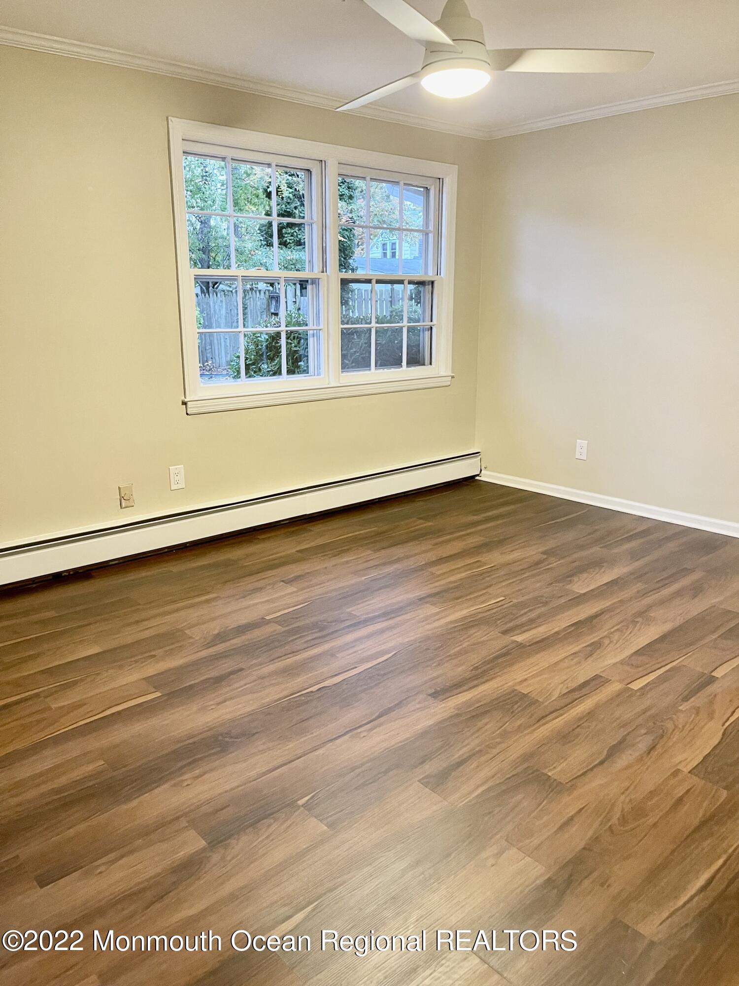 641 Thoroughfare Road Brick, NJ 08724 - Photo 40 of 48 an empty room with wooden floor and windows