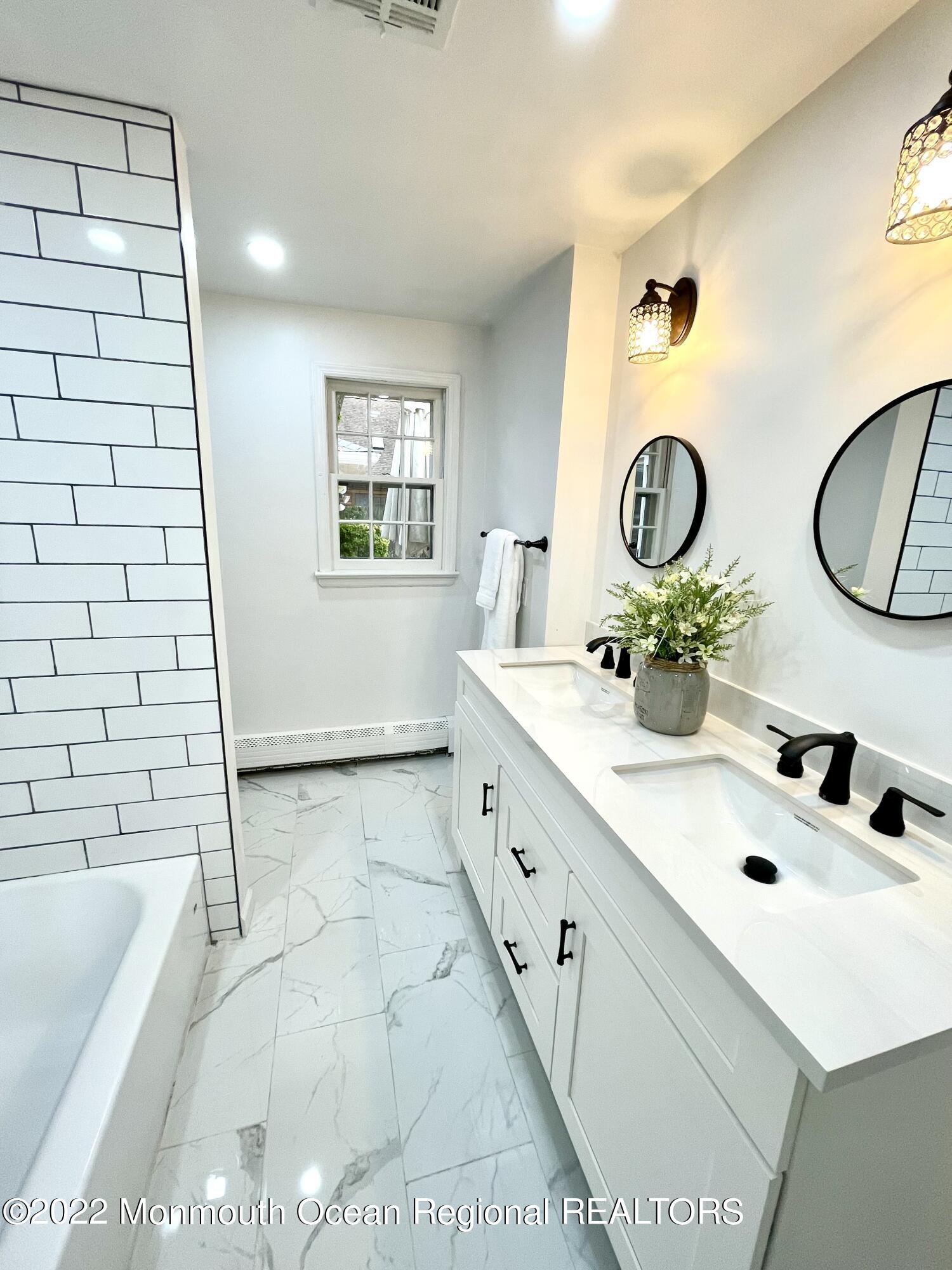 641 Thoroughfare Road Brick, NJ 08724 - Photo 4 of 48 a bathroom with a sink and a mirror