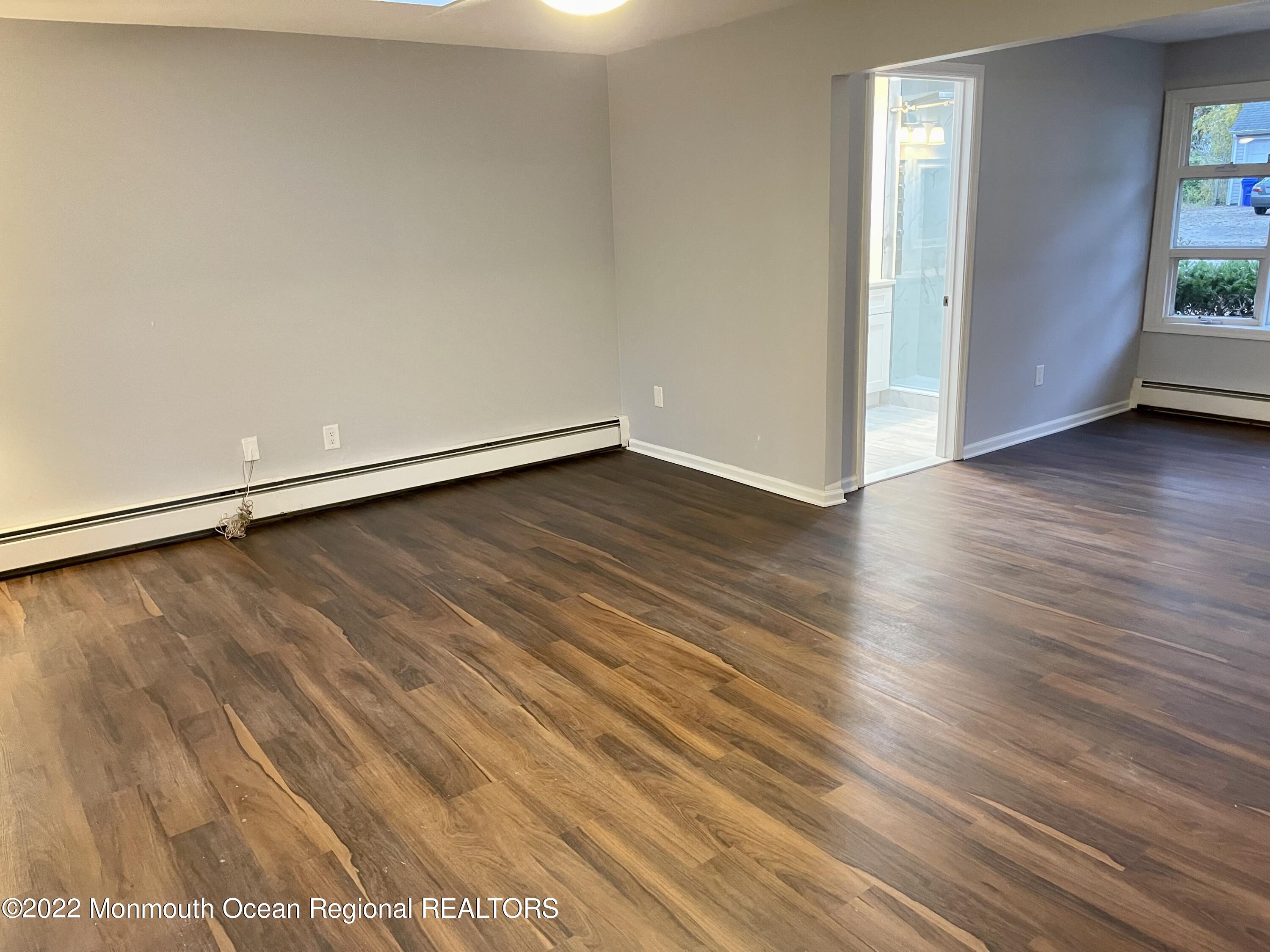 641 Thoroughfare Road Brick, NJ 08724 - Photo 43 of 48 a view of an empty room with wooden floor and a window