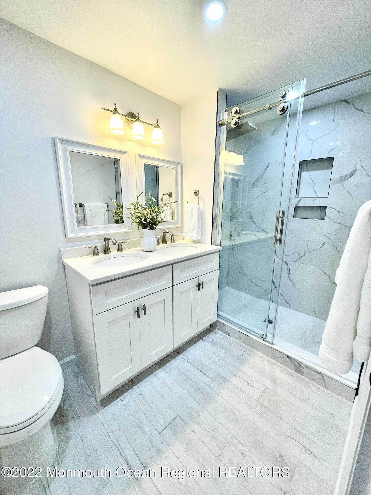 641 Thoroughfare Road Brick, NJ 08724 - Photo 6 of 48 a spacious bathroom with a shower sink mirror and toilet