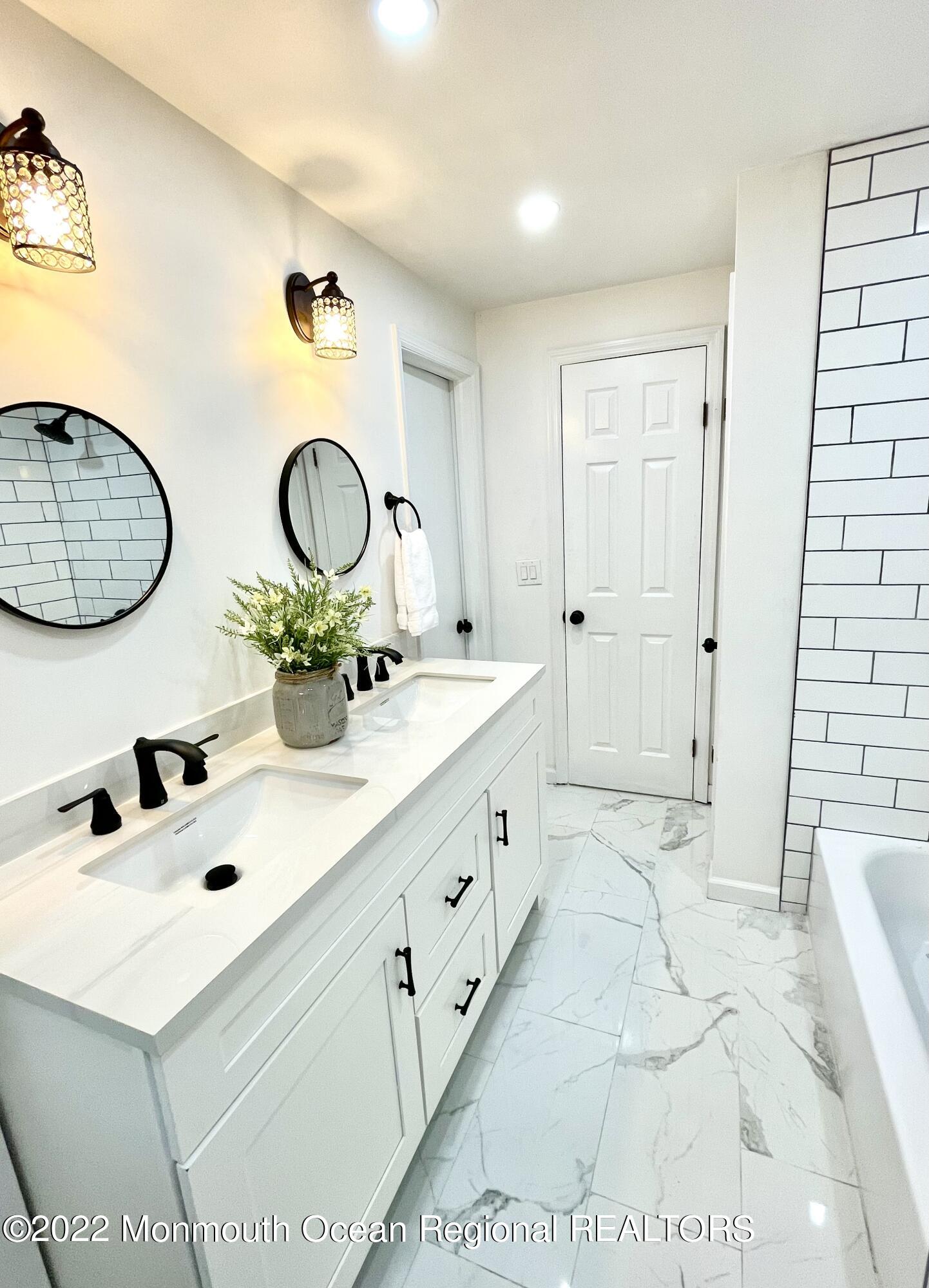 641 Thoroughfare Road Brick, NJ 08724 - Photo 8 of 48 a bathroom with a double vanity sink mirror and