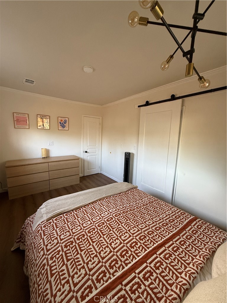 3359 Locust Street Riverside, CA 92501 - Photo 14 of 23 a bedroom with a bed and cabinets