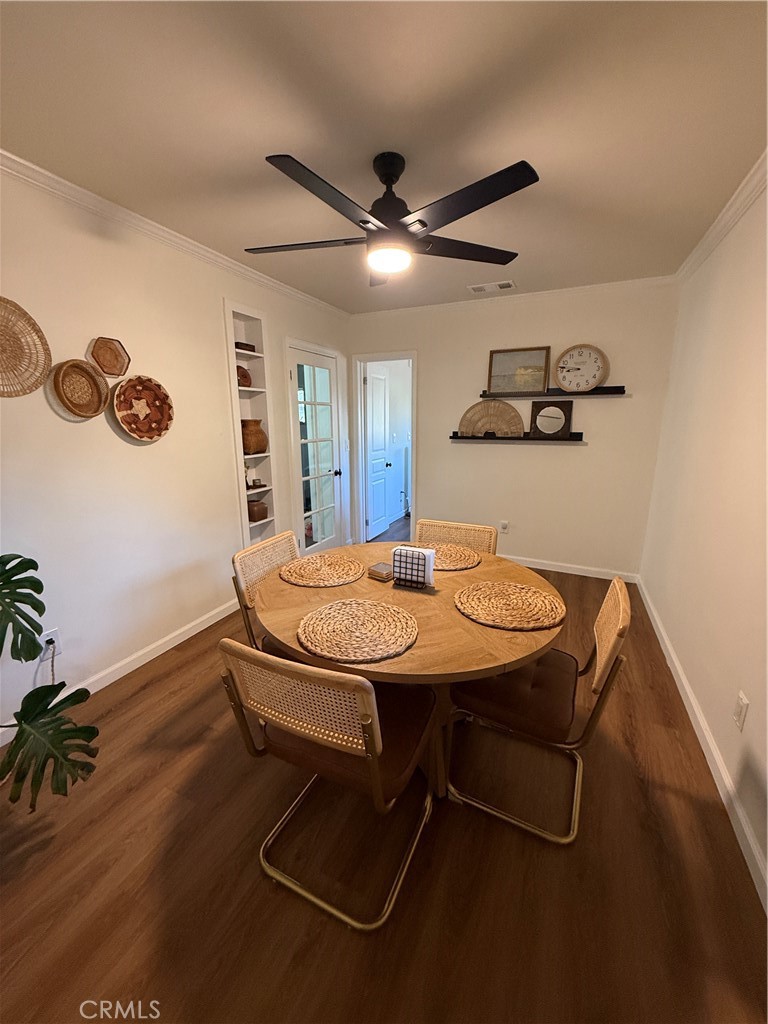 3359 Locust Street Riverside, CA 92501 - Photo 16 of 23 a room with a table chairs and wooden floor