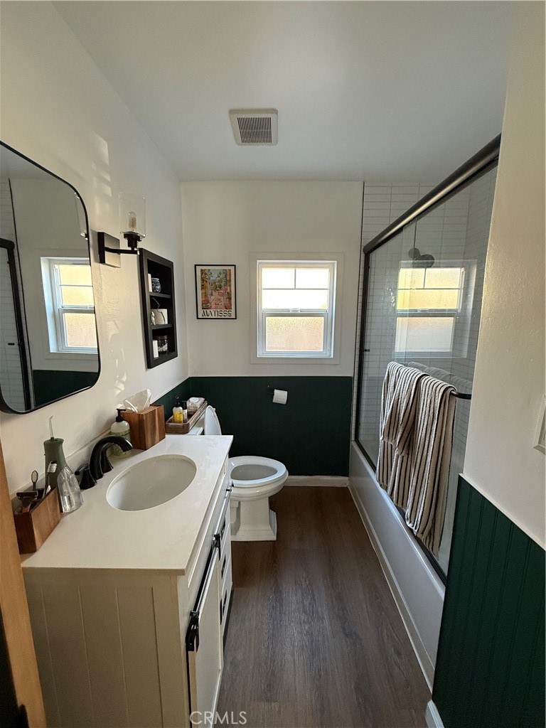 3359 Locust Street Riverside, CA 92501 - Photo 19 of 23 a bathroom with a sink a toilet and mirror