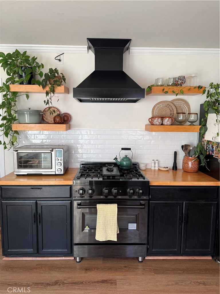 3359 Locust Street Riverside, CA 92501 - Photo 2 of 23 a kitchen with stainless steel appliances granite countertop a stove and a microwave