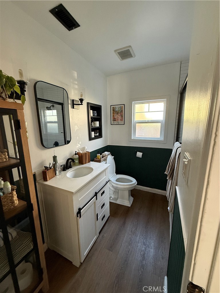 3359 Locust Street Riverside, CA 92501 - Photo 21 of 23 a en suite bathroom with a toilet sink and mirror