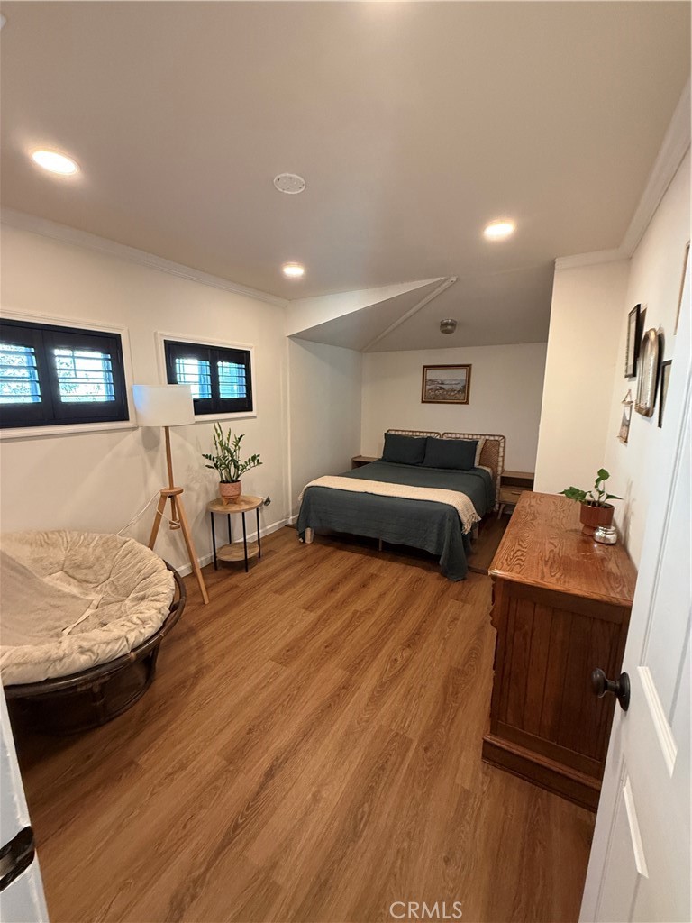 3359 Locust Street Riverside, CA 92501 - Photo 8 of 23 a bedroom with furniture and wooden floor