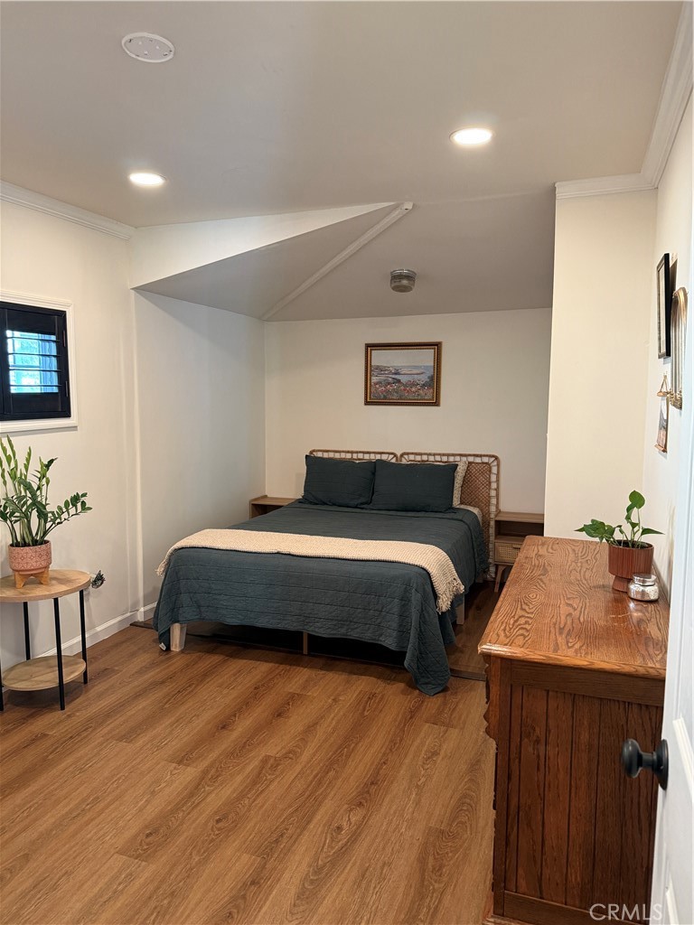3359 Locust Street Riverside, CA 92501 - Photo 9 of 23 a bedroom with double bed and a potted plant