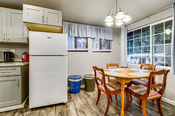a bedroom with a bed a painting and a lamp