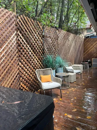 a wooden house with a large window and wooden fence